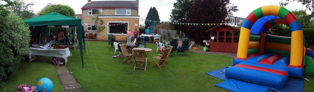 Empty garden with bouncy castle, chairs and stalls